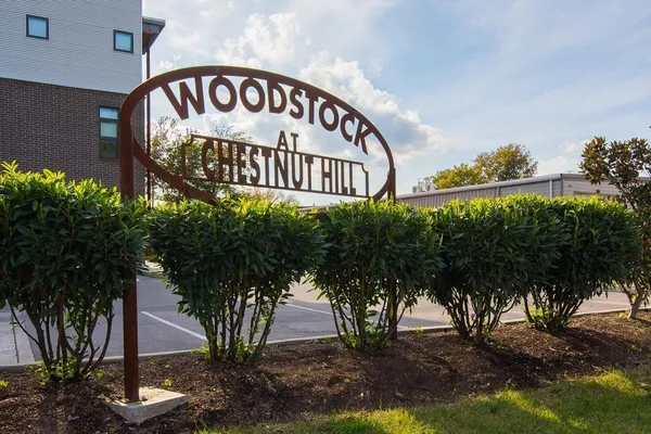 a view of a sign under a tree