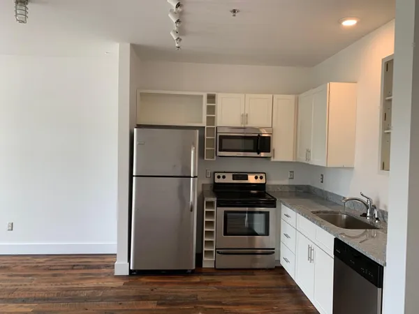 a kitchen with stainless steel appliances a refrigerator stove and microwave