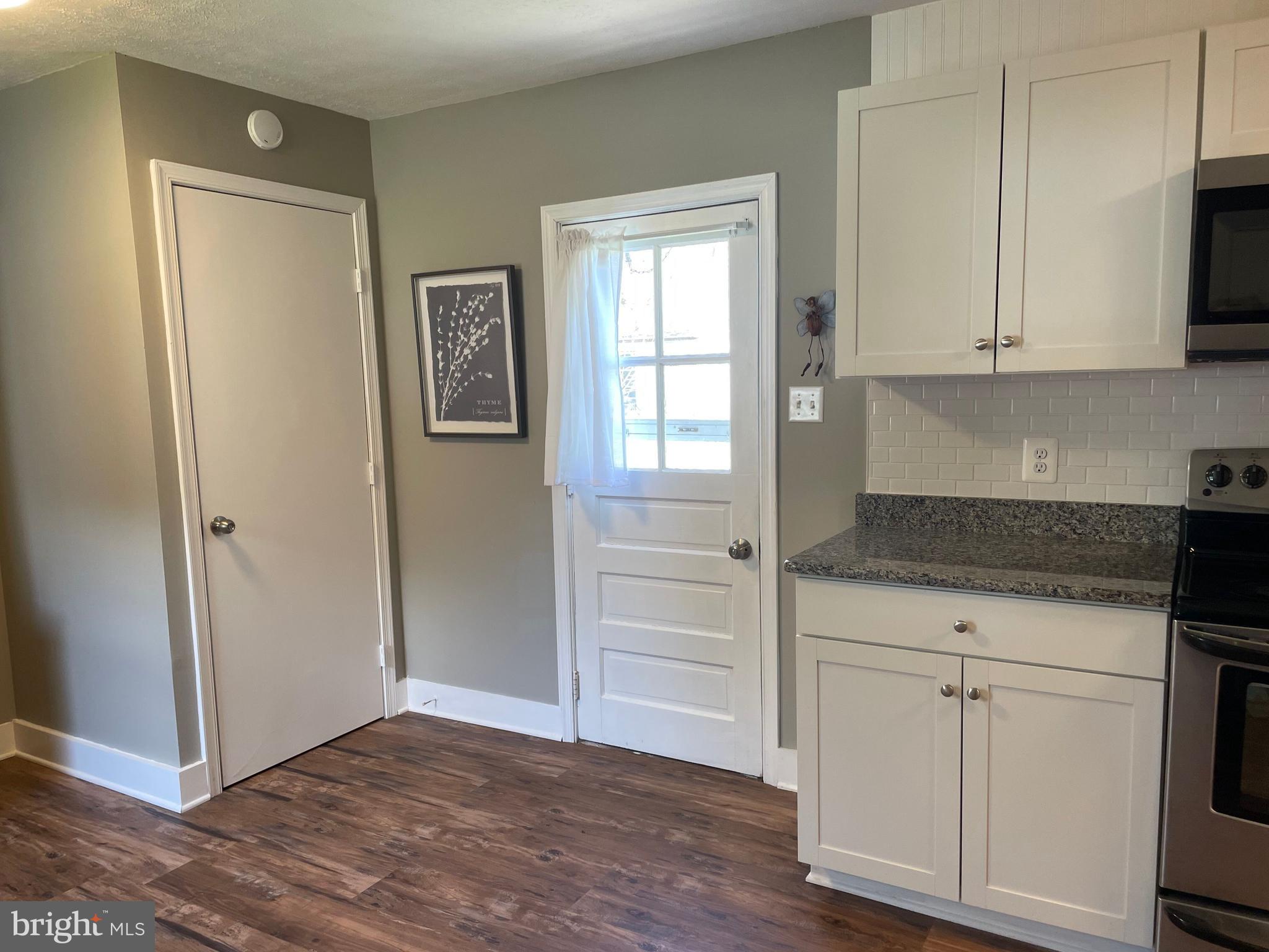 5 Oak Street Cambridge, MD 21613 - Photo 16 of 31 a kitchen with white cabinets and sink