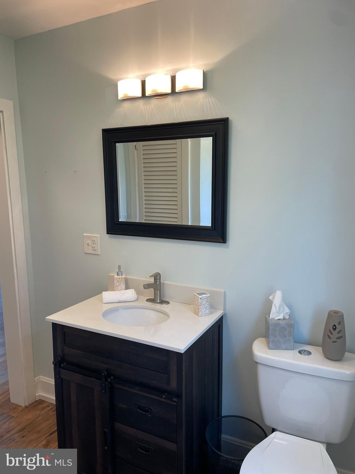 5 Oak Street Cambridge, MD 21613 - Photo 21 of 31 a bathroom with a toilet sink and mirror