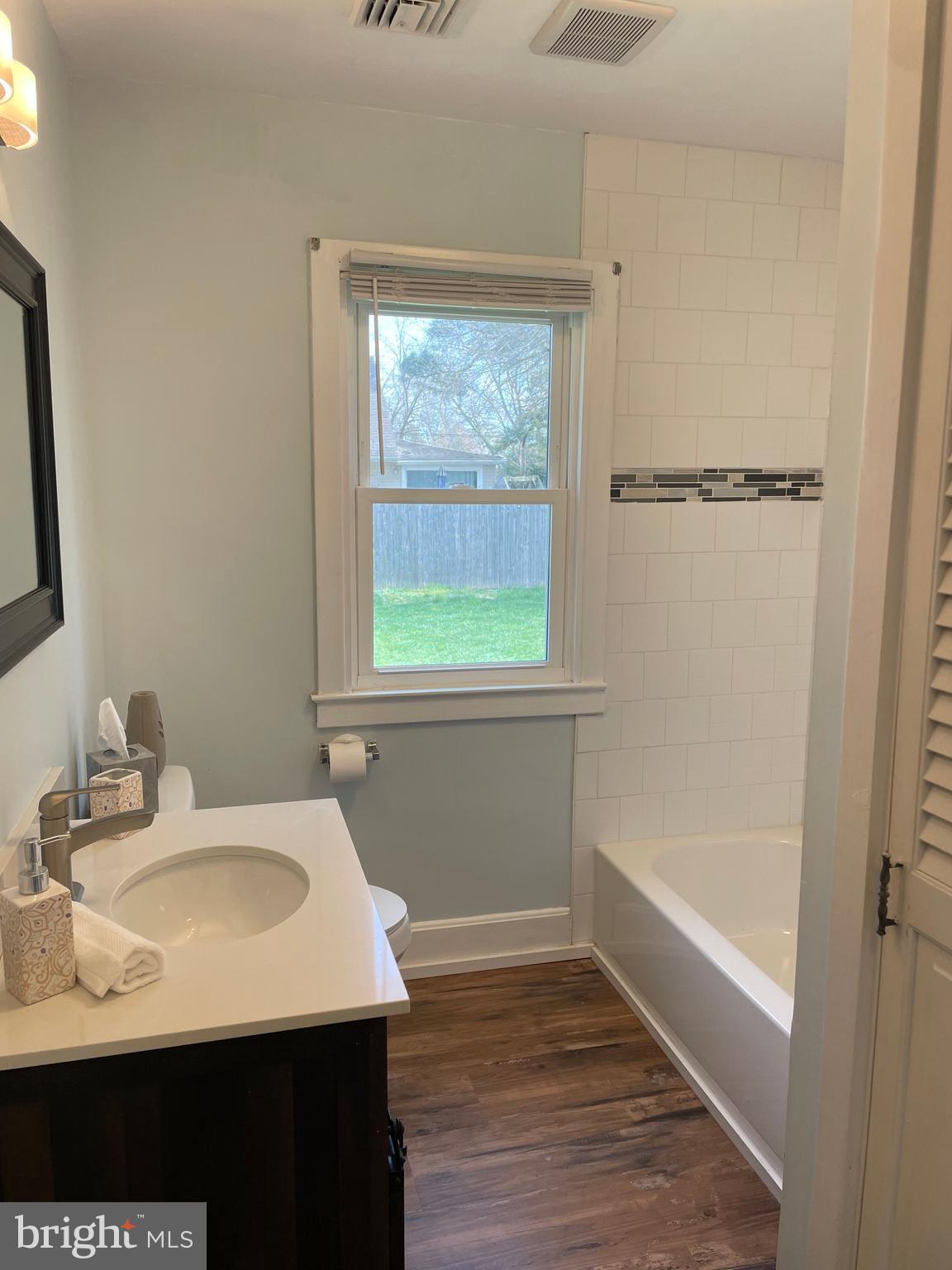 5 Oak Street Cambridge, MD 21613 - Photo 22 of 31 a bathroom with a sink and a mirror