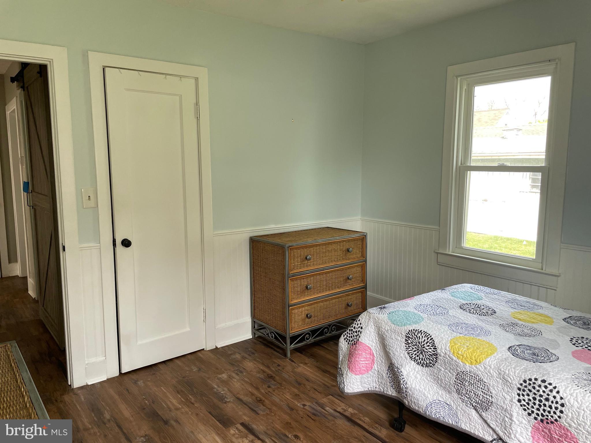 5 Oak Street Cambridge, MD 21613 - Photo 26 of 31 a bedroom with a bed and wooden floor