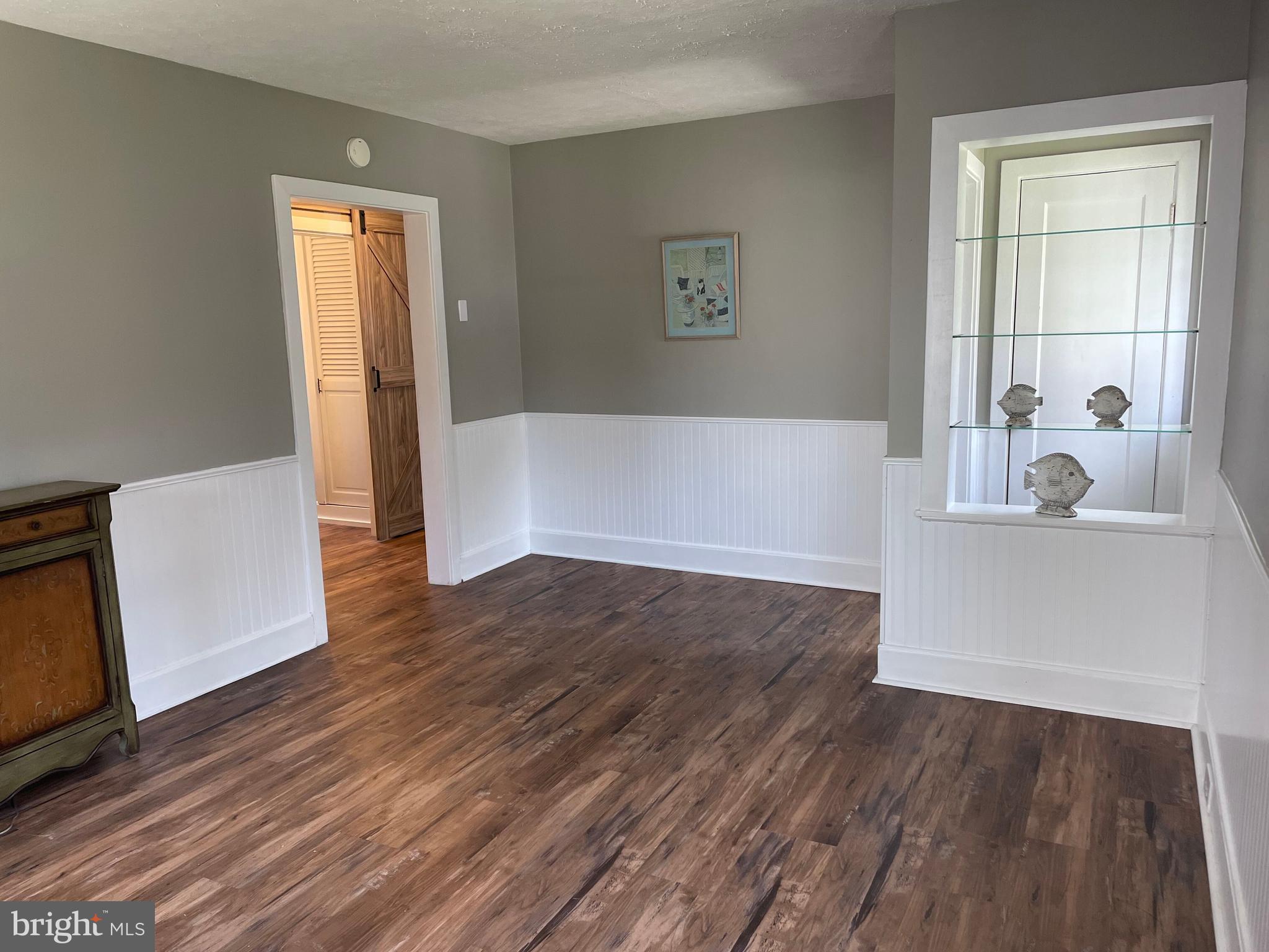 5 Oak Street Cambridge, MD 21613 - Photo 4 of 31 a view of a room with wooden floor and a window