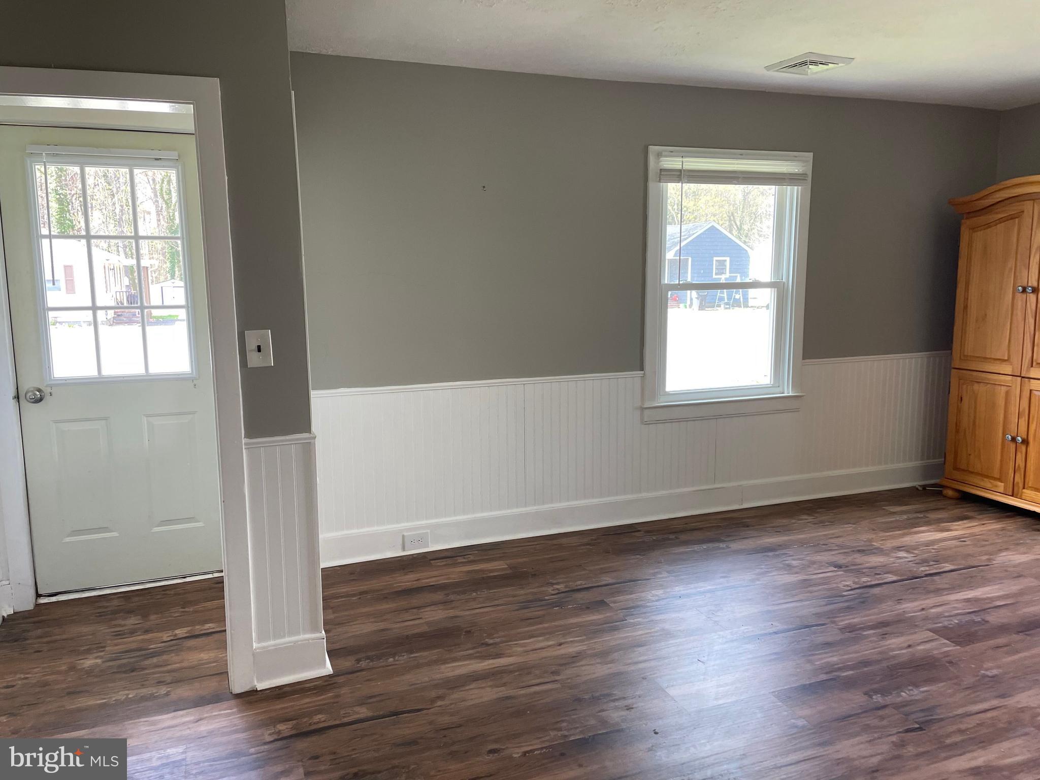 5 Oak Street Cambridge, MD 21613 - Photo 7 of 31 an empty room with wooden floor and windows