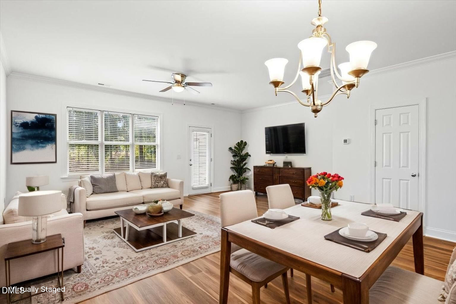 305 West Savannah Ridge Road Holly Springs, NC 27540 - Photo 11 of 34 a living room with furniture a flat screen tv and a chandelier