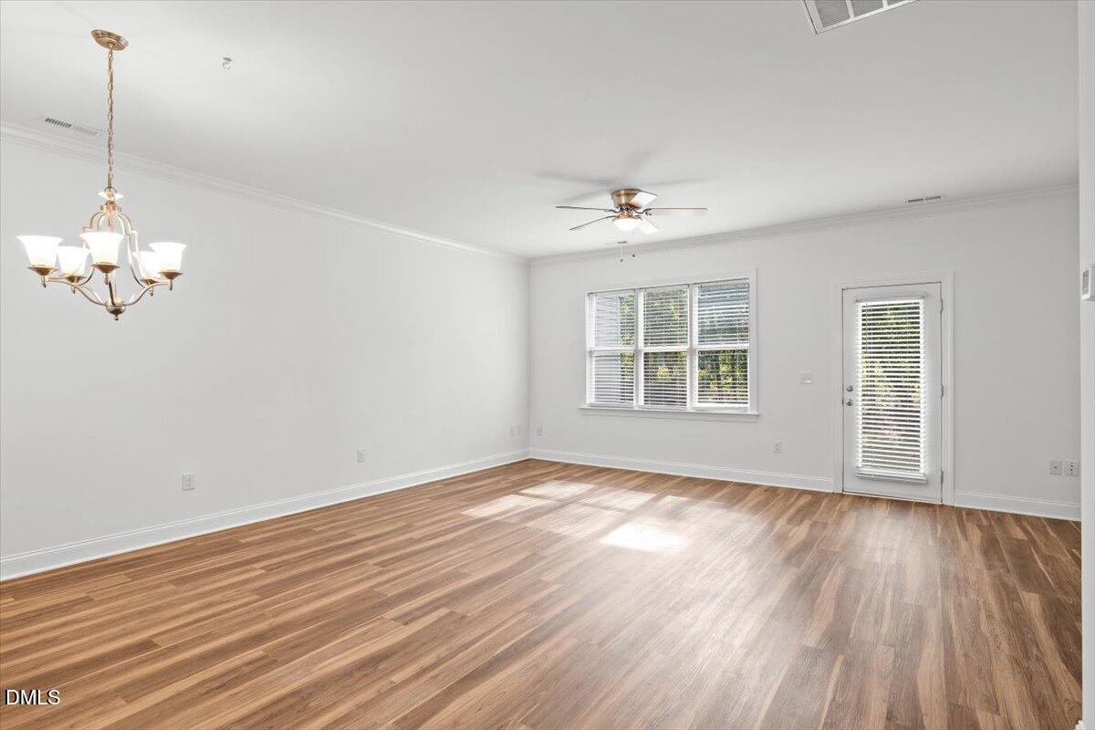 305 West Savannah Ridge Road Holly Springs, NC 27540 - Photo 12 of 34 a view of empty room with wooden floor and fan
