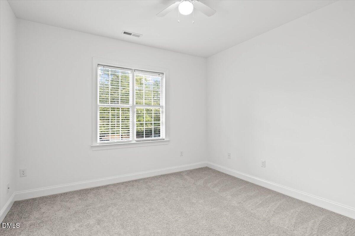 305 West Savannah Ridge Road Holly Springs, NC 27540 - Photo 19 of 34 an empty room with a window