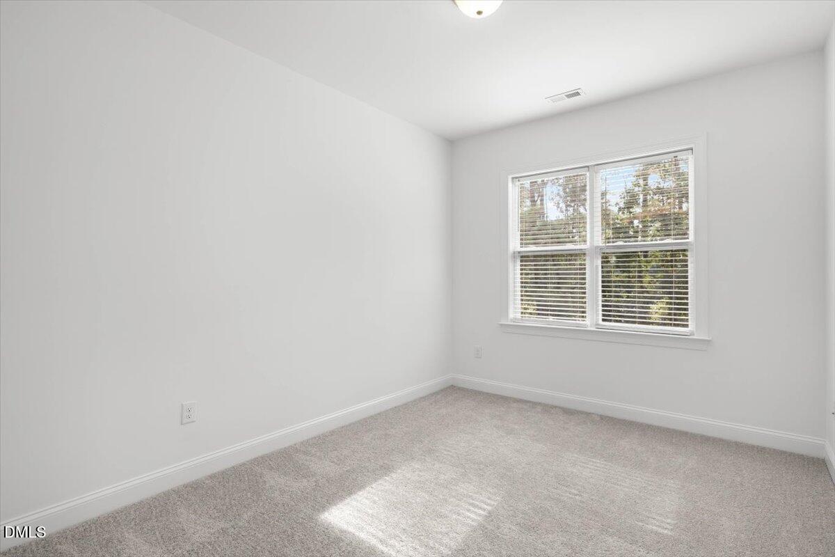 305 West Savannah Ridge Road Holly Springs, NC 27540 - Photo 24 of 34 an empty room with a window