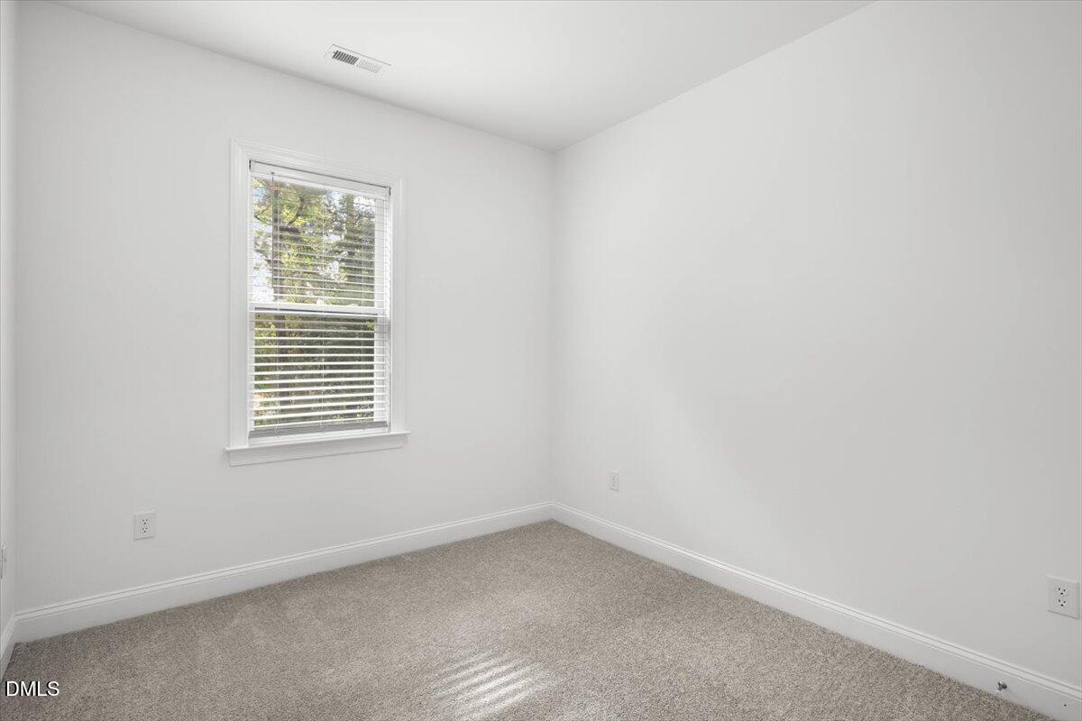 305 West Savannah Ridge Road Holly Springs, NC 27540 - Photo 26 of 34 an empty room with a window