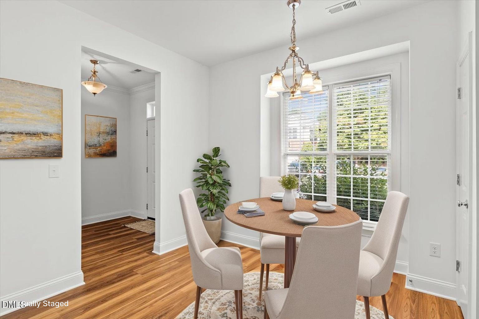 305 West Savannah Ridge Road Holly Springs, NC 27540 - Photo 4 of 34 a view of a dining room with furniture window and wooden floor