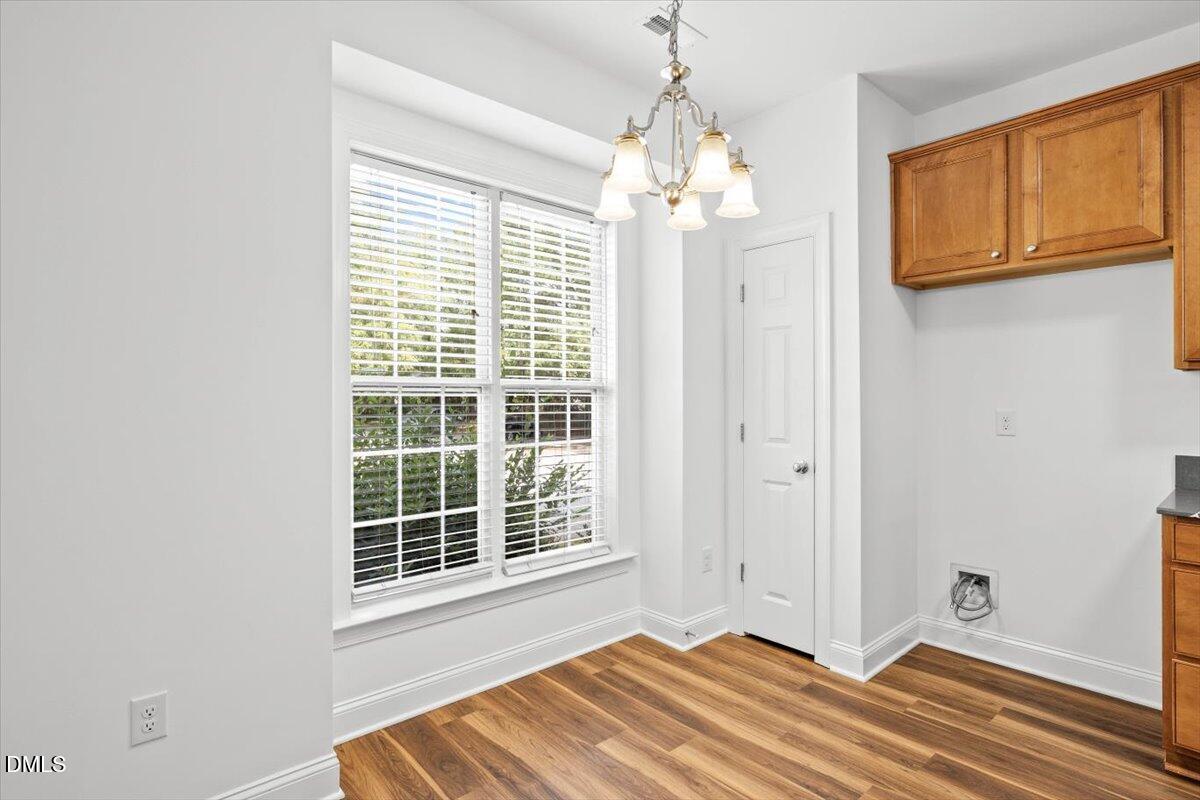 305 West Savannah Ridge Road Holly Springs, NC 27540 - Photo 6 of 34 a view of a spacious bedroom with windows and chandelier