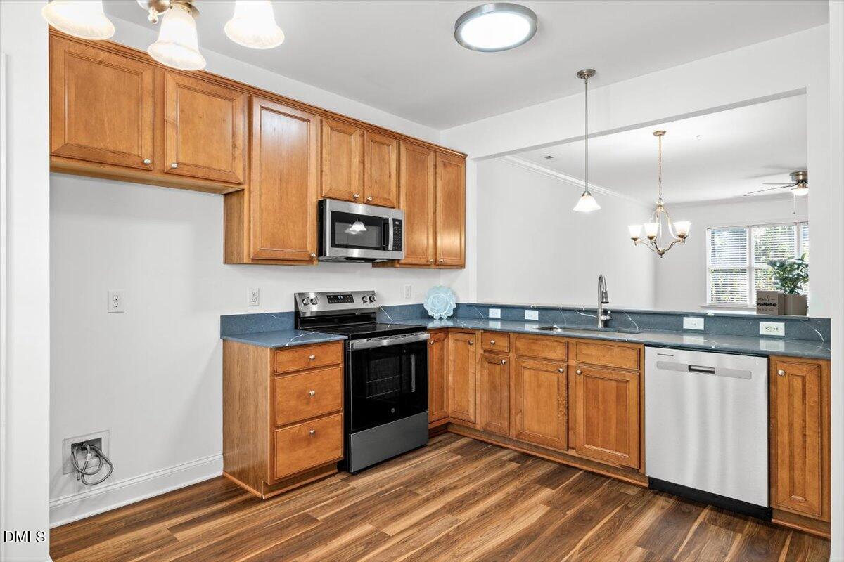 305 West Savannah Ridge Road Holly Springs, NC 27540 - Photo 7 of 34 a kitchen with stainless steel appliances granite countertop a stove a sink and a microwave