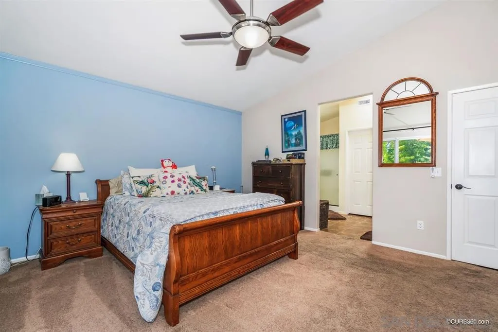 2332 Columbine Road Alpine, CA 91901 - Photo 12 of 25 a bedroom with a bed and a chandelier
