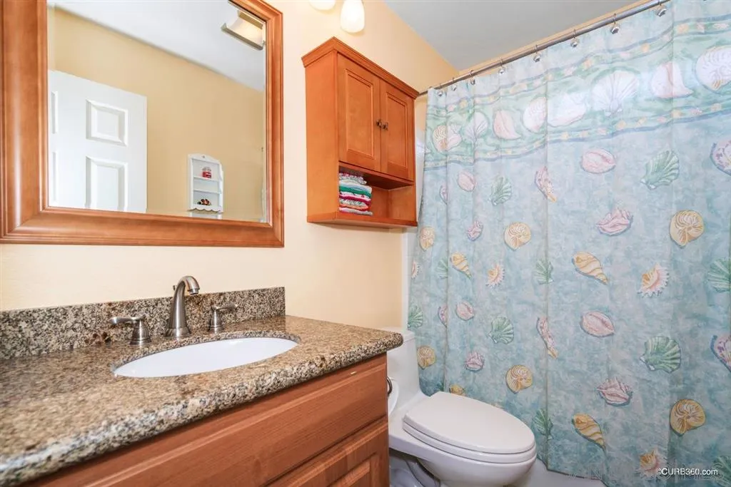 2332 Columbine Road Alpine, CA 91901 - Photo 15 of 25 a bathroom with a granite countertop sink mirror vanity and toilet