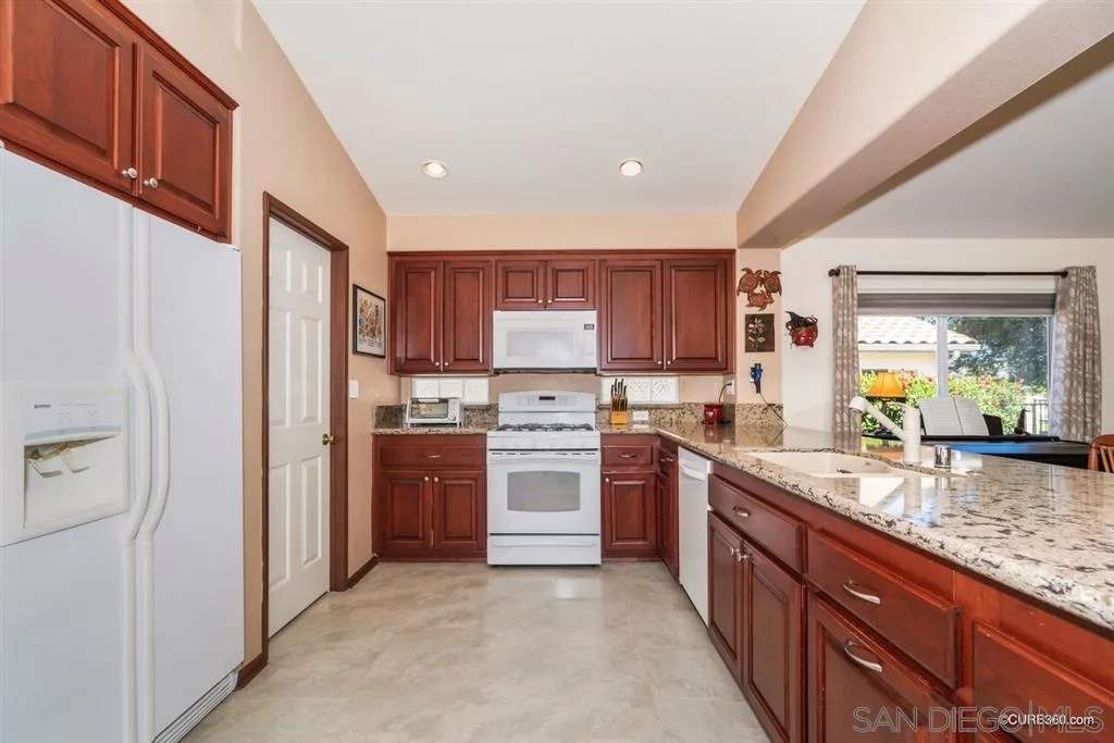 2332 Columbine Road Alpine, CA 91901 - Photo 3 of 25 a kitchen with stainless steel appliances granite countertop a refrigerator and a stove top oven
