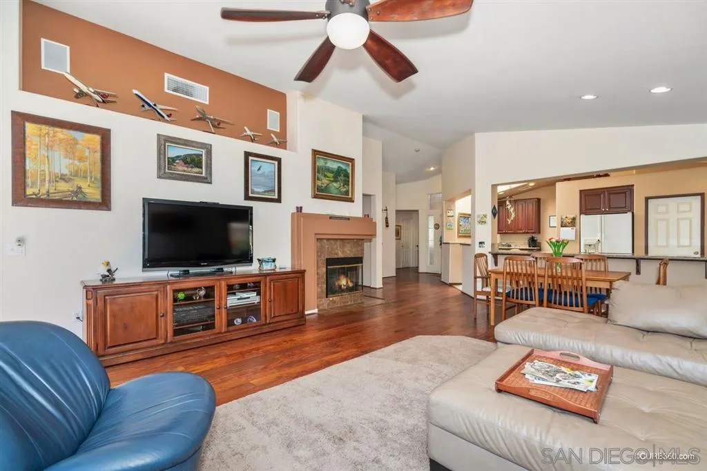 2332 Columbine Road Alpine, CA 91901 - Photo 8 of 25 a living room with furniture a flat screen tv and a fireplace