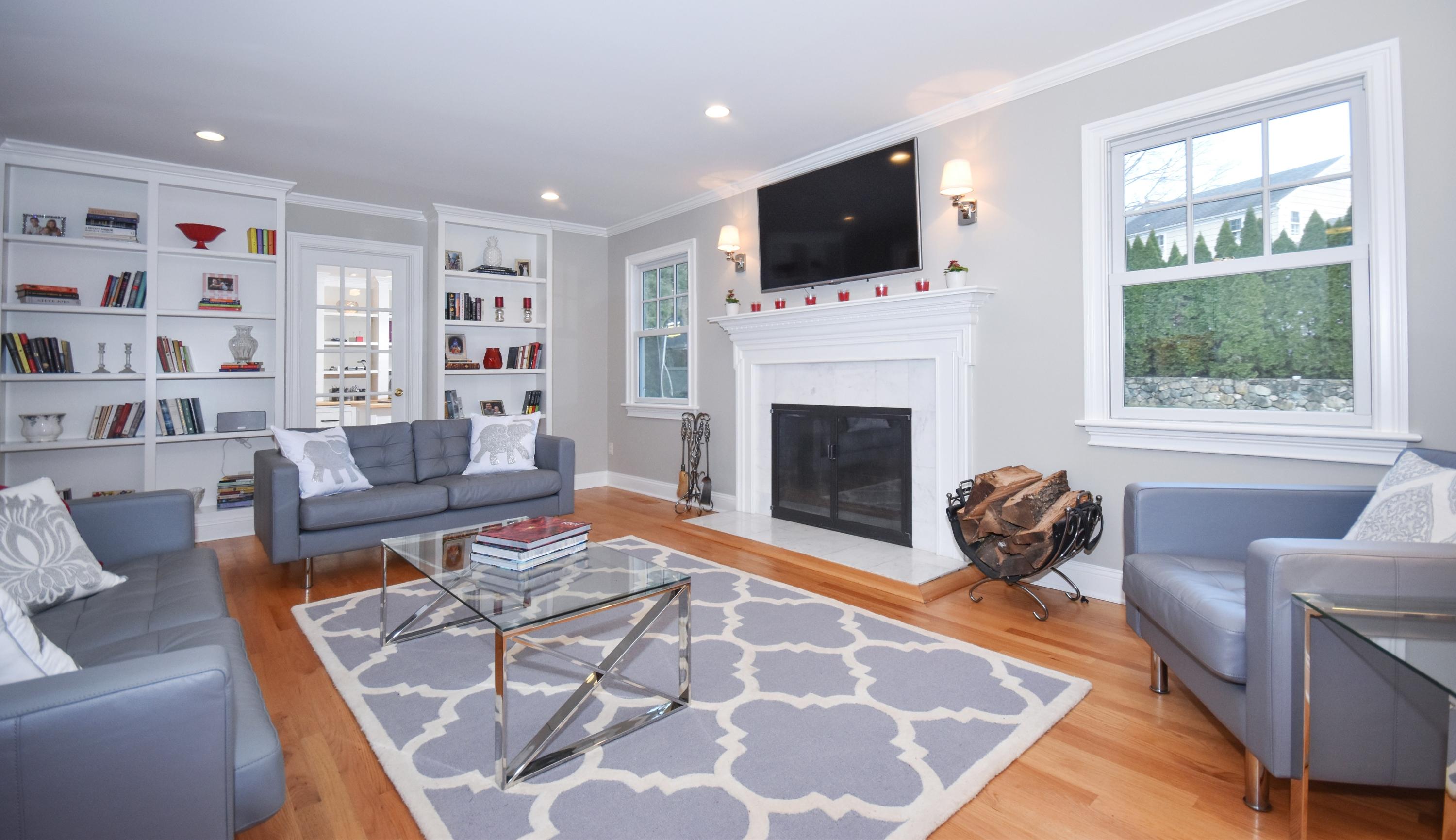 10 Barringer Road Darien, CT 06820 - Photo 12 of 27 a living room with furniture a flat screen tv and a fireplace