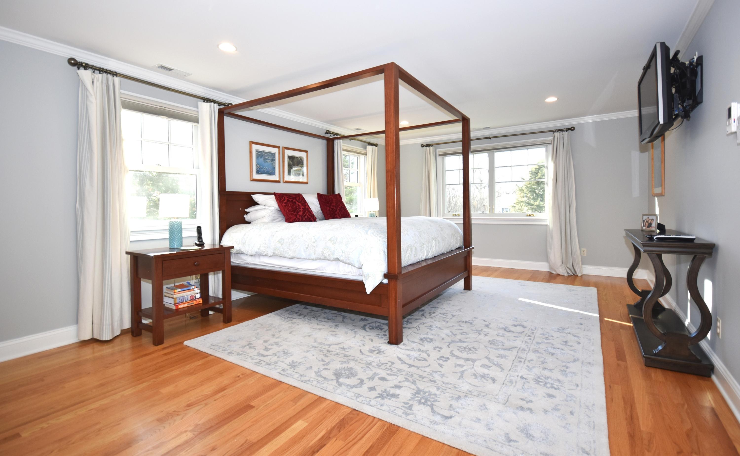 10 Barringer Road Darien, CT 06820 - Photo 15 of 27 a bedroom with a bed and wooden floor