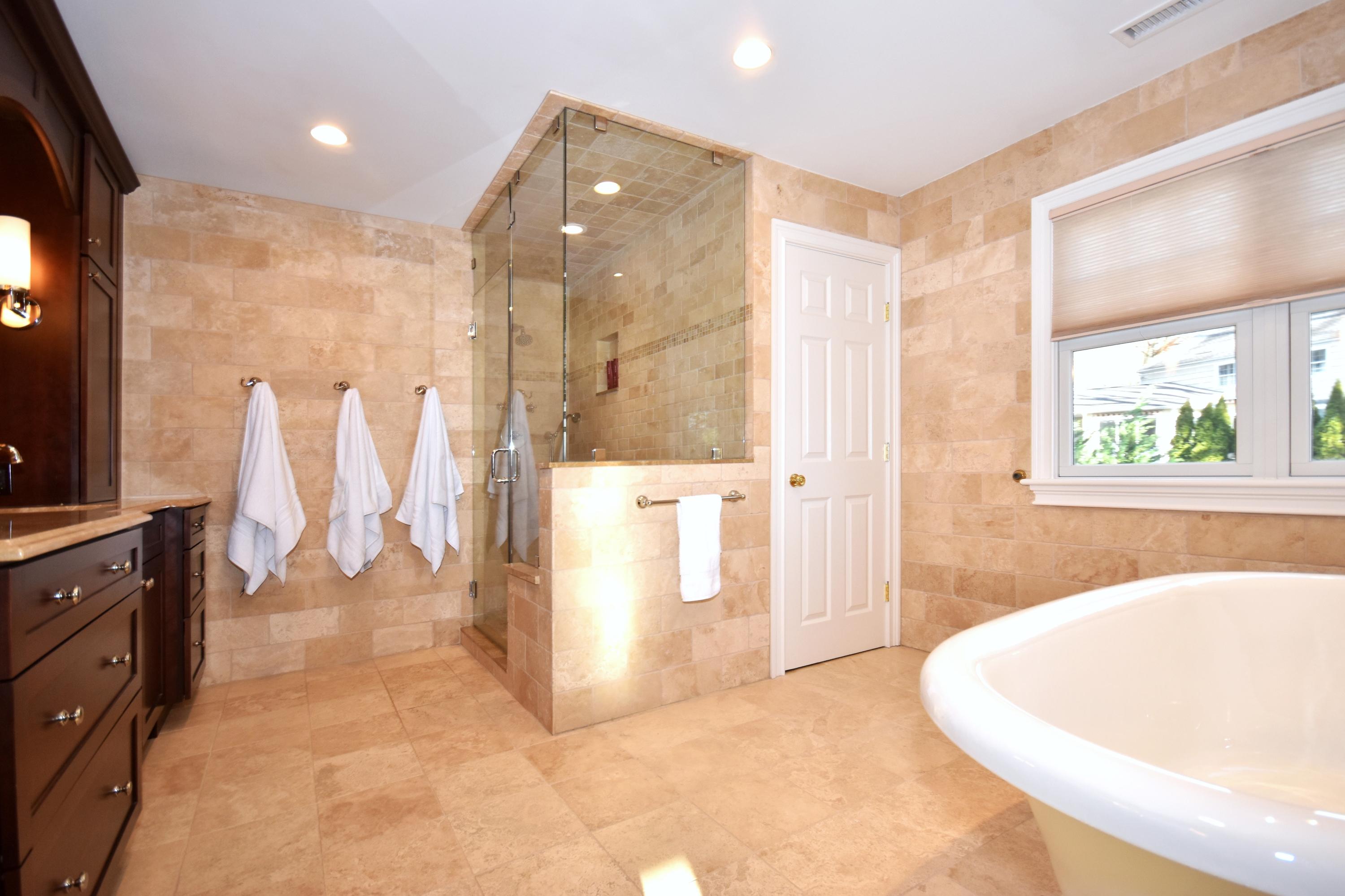 10 Barringer Road Darien, CT 06820 - Photo 16 of 27 a spacious bathroom with a tub shower and sink