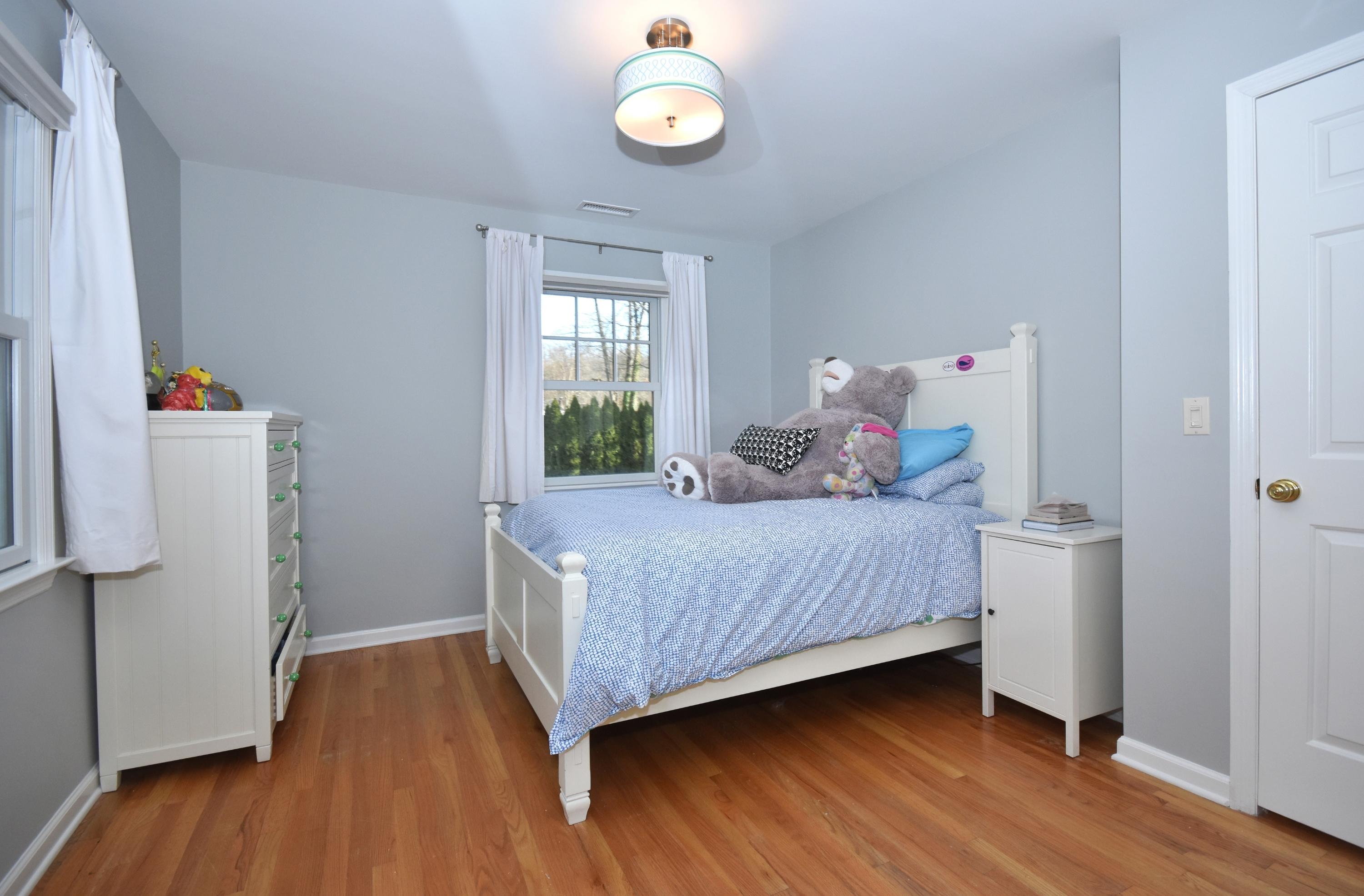10 Barringer Road Darien, CT 06820 - Photo 20 of 27 a bedroom with a bed and a window