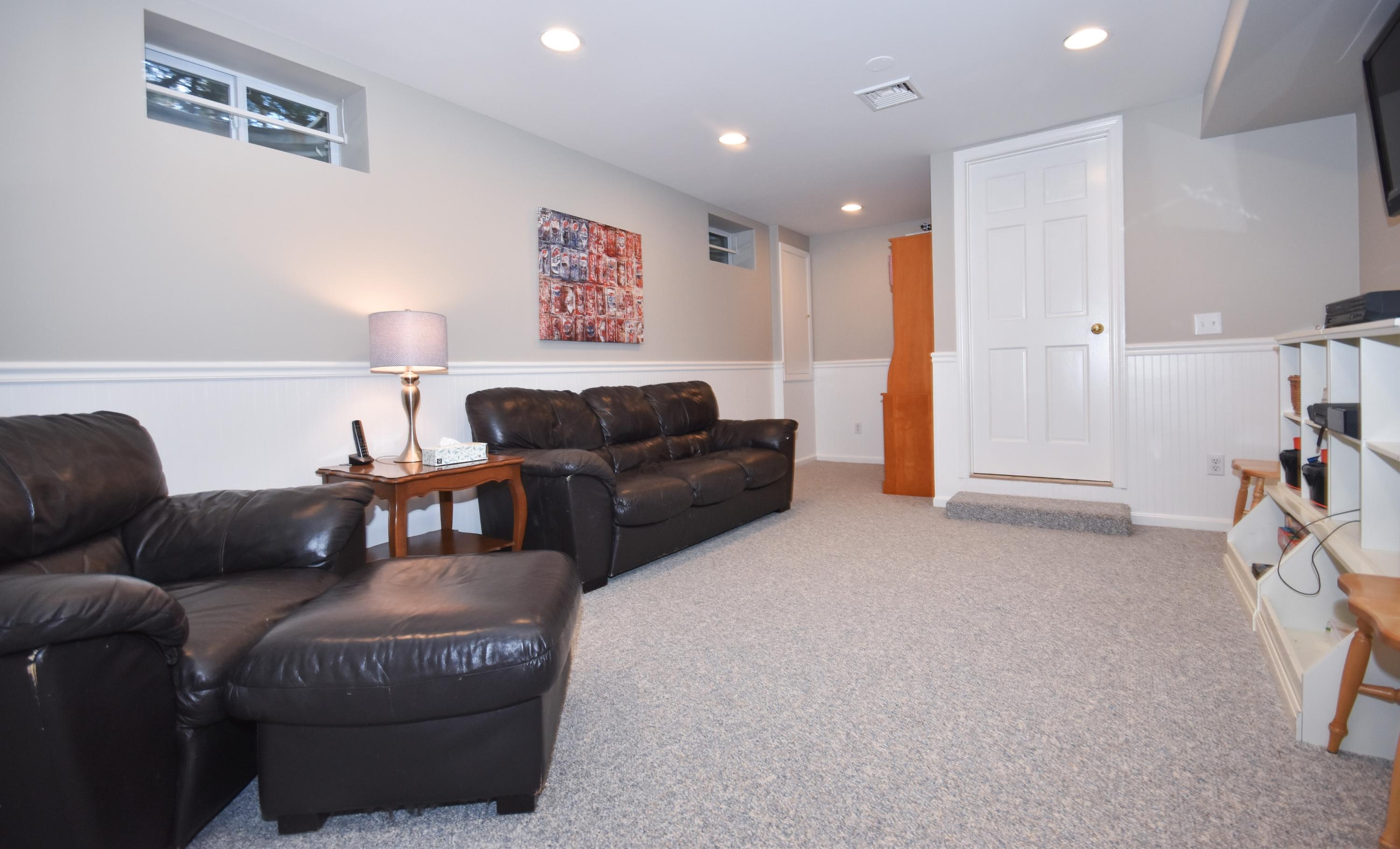 10 Barringer Road Darien, CT 06820 - Photo 24 of 27 a living room with furniture and a couch