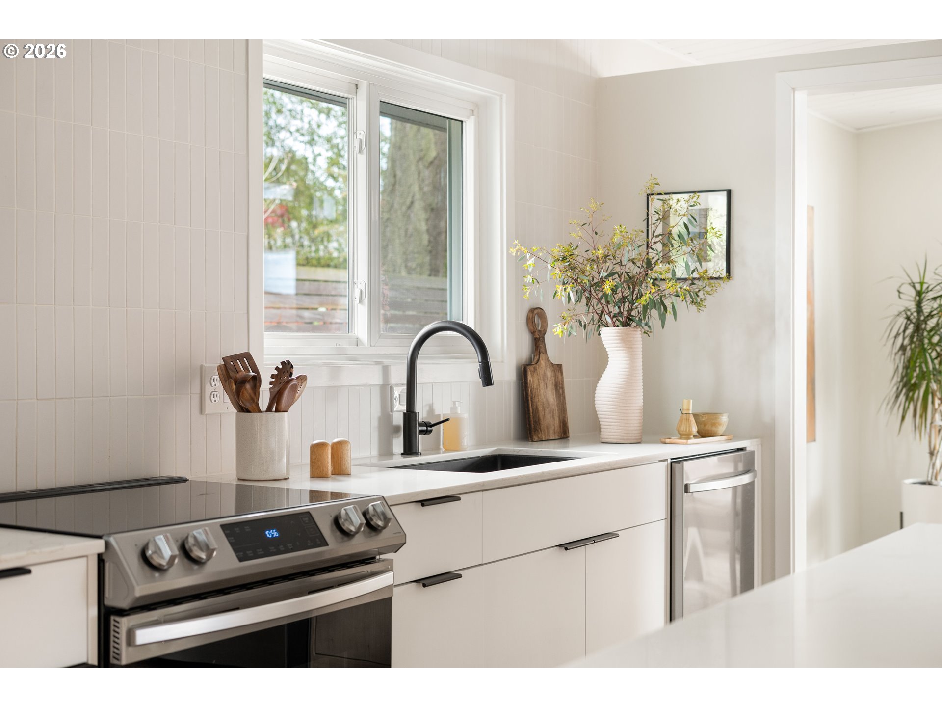 7125 Southwest 105th Avenue Beaverton, OR 97008 - Photo 16 of 39 a kitchen with a stove and a white cabinet