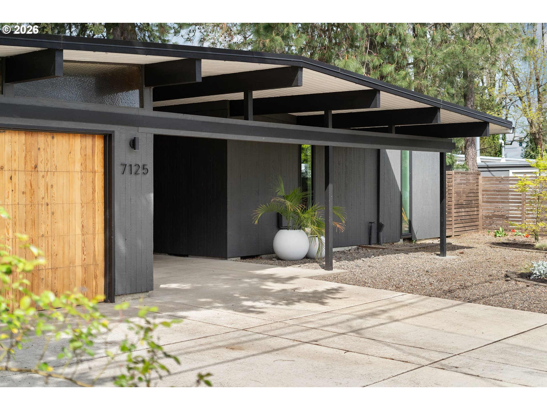 7125 Southwest 105th Avenue Beaverton, OR 97008 - Photo 2 of 39 a view of a wooden house with a outdoor space