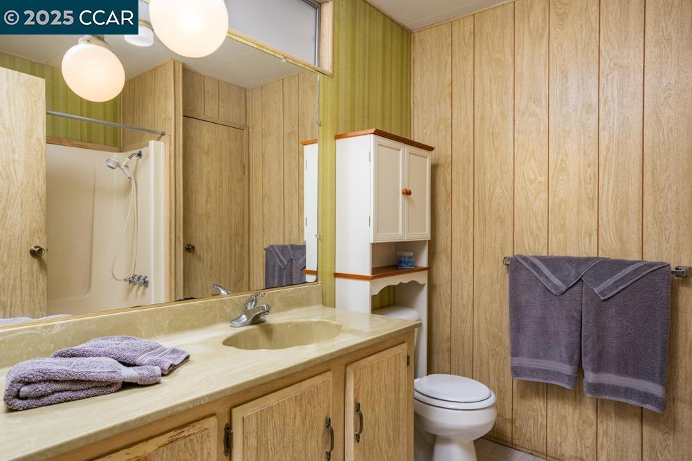 2110 Dalis Drive Concord, CA 94520 - Photo 19 of 30 a bathroom with a granite countertop sink and a mirror with toilet