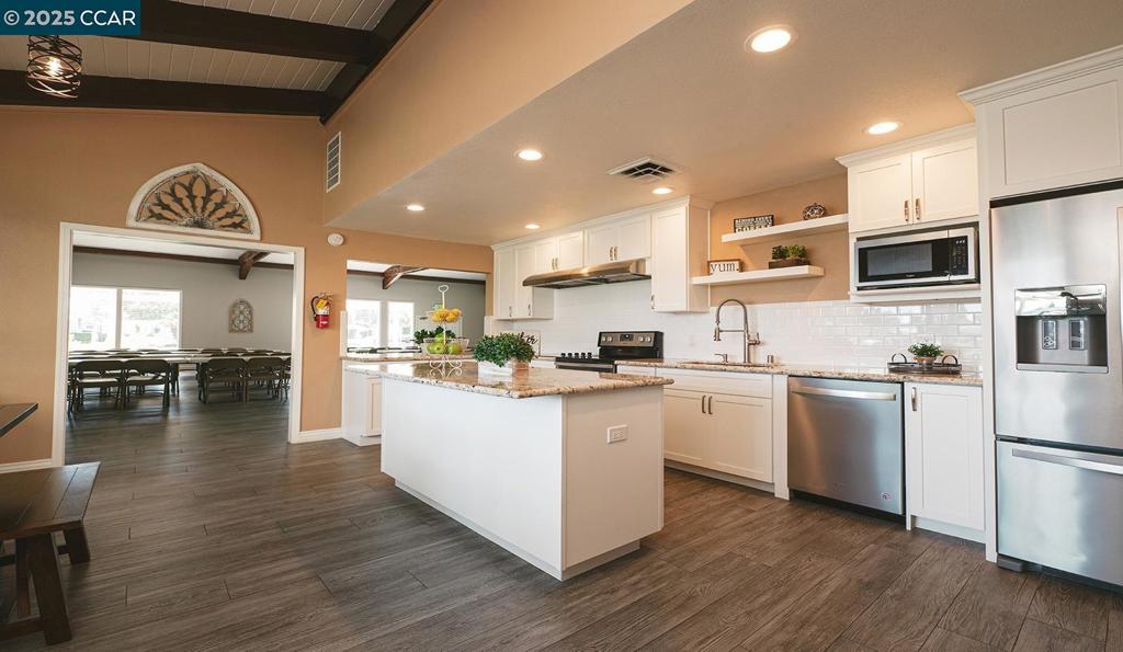 2110 Dalis Drive Concord, CA 94520 - Photo 30 of 30 a kitchen with white cabinets and stainless steel appliances