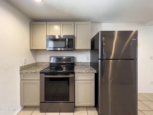 a kitchen with a stove and a refrigerator
