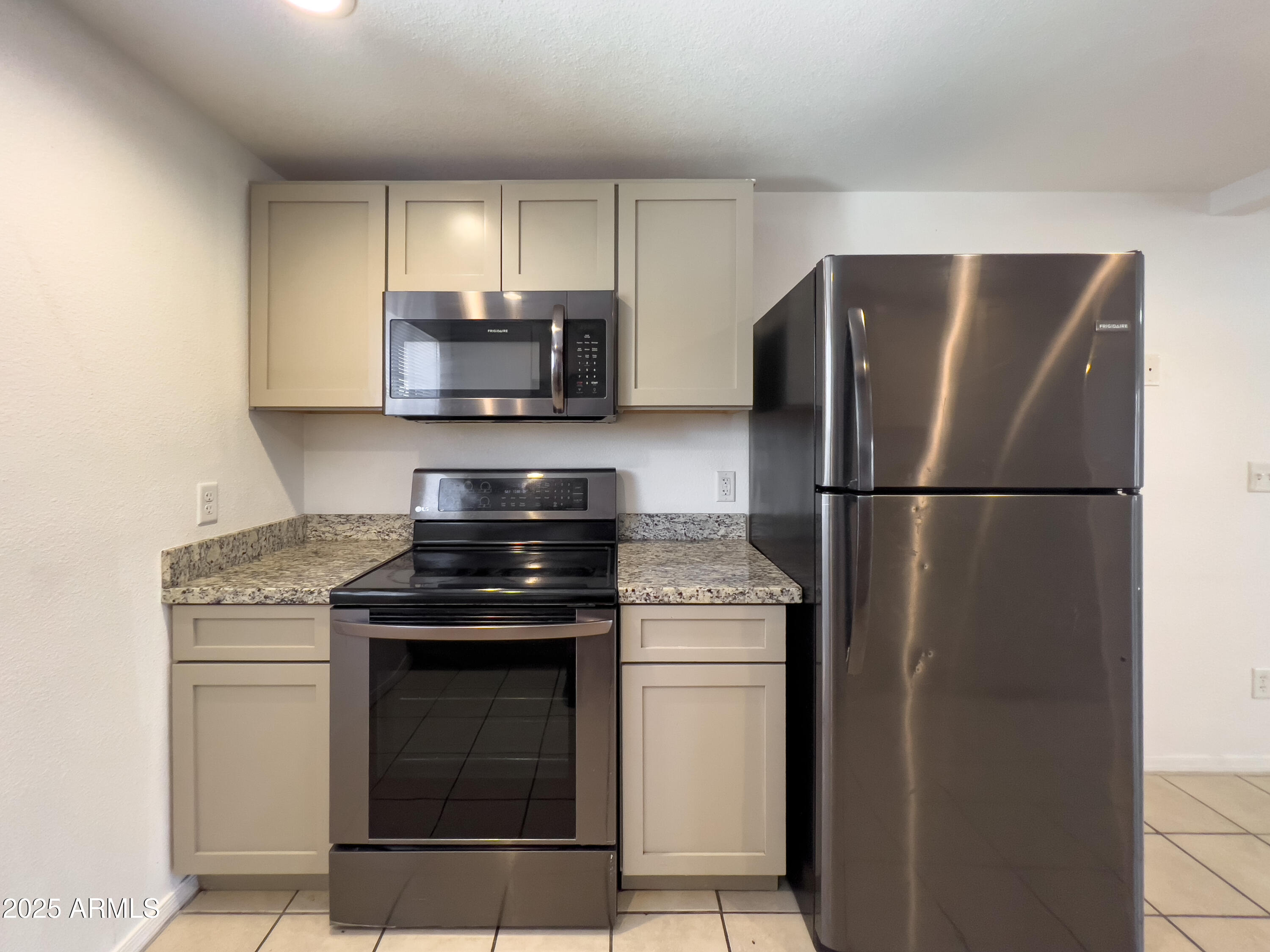 a kitchen with a stove and a refrigerator