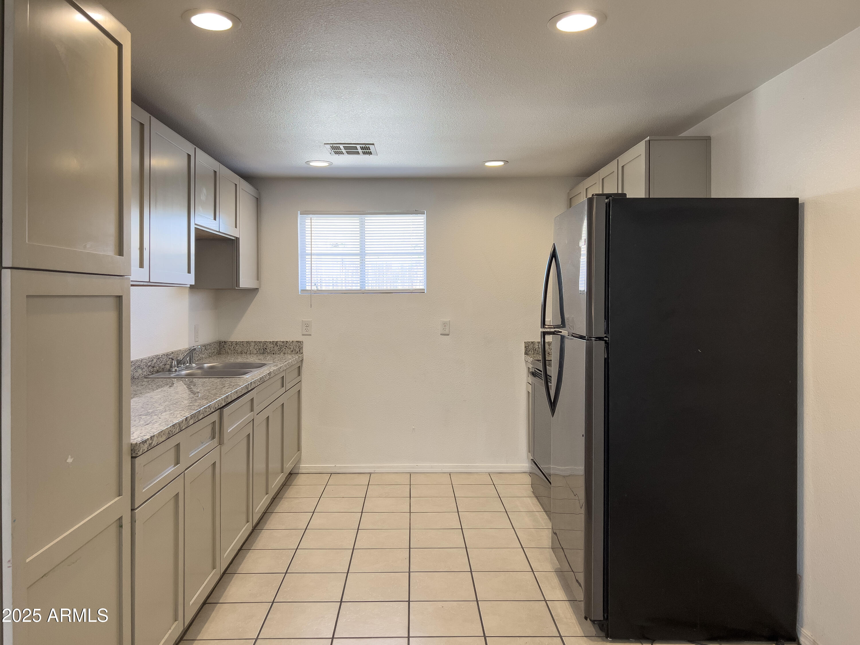 1520 West Sahuaro Drive, Unit B Phoenix, AZ 85029 - Photo 10 of 25 a kitchen with a refrigerator and a sink