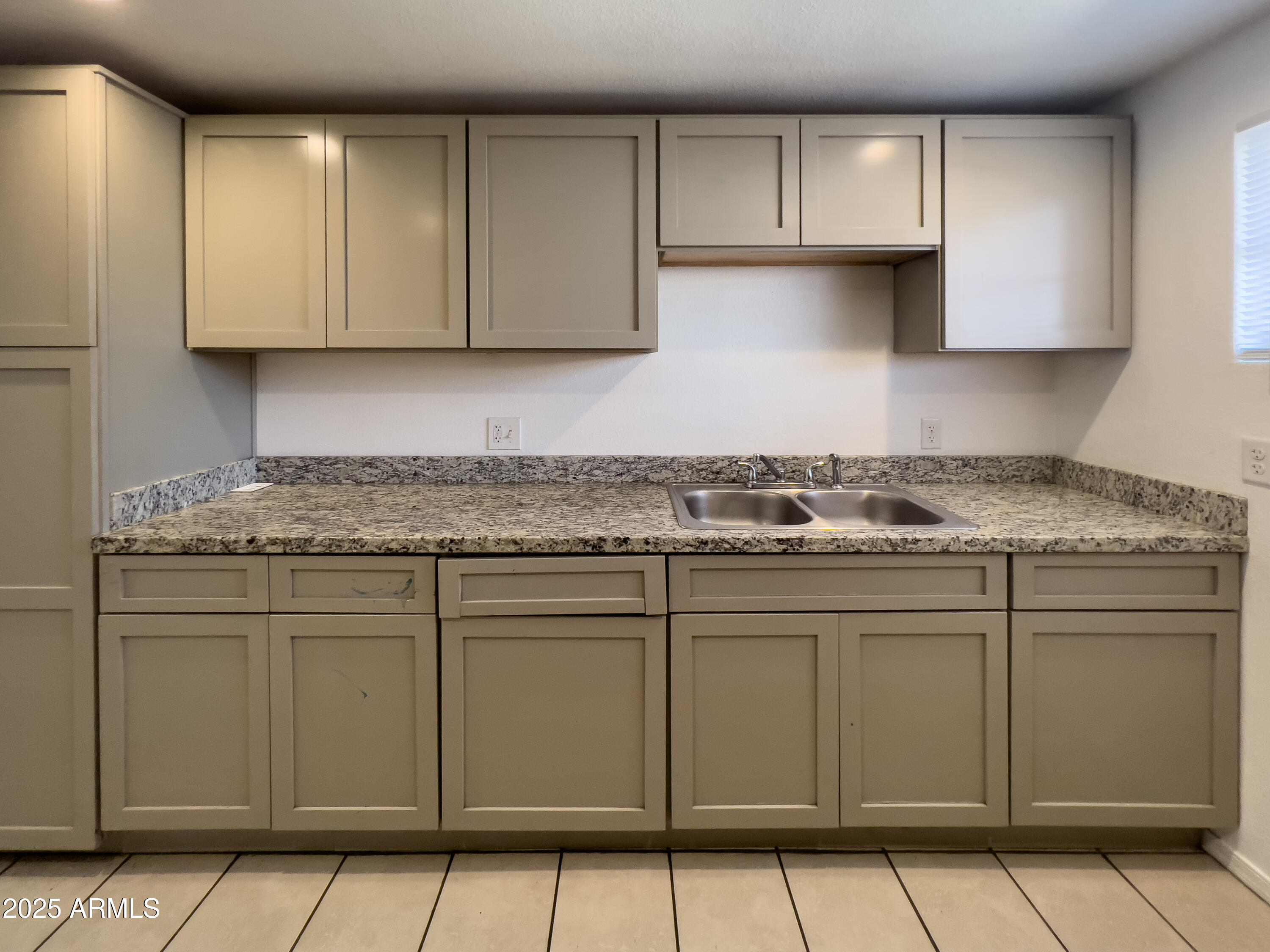 1520 West Sahuaro Drive, Unit B Phoenix, AZ 85029 - Photo 12 of 25 a kitchen with granite countertop white cabinets and stainless steel appliances