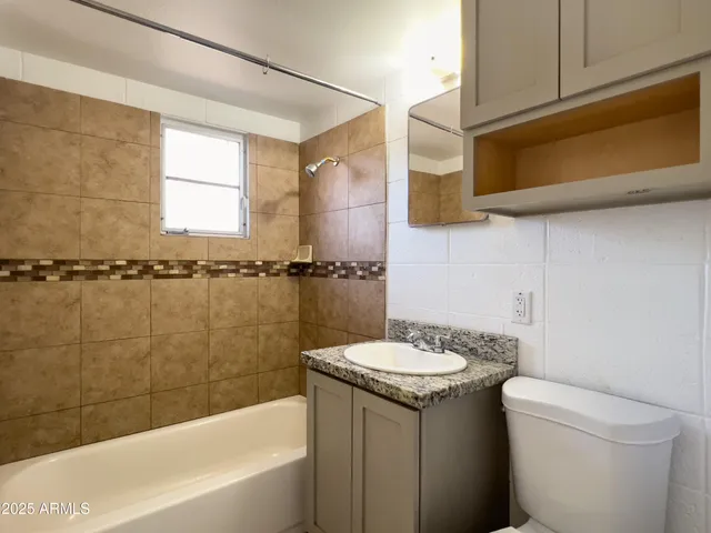 a view of an empty room and chandelier fan