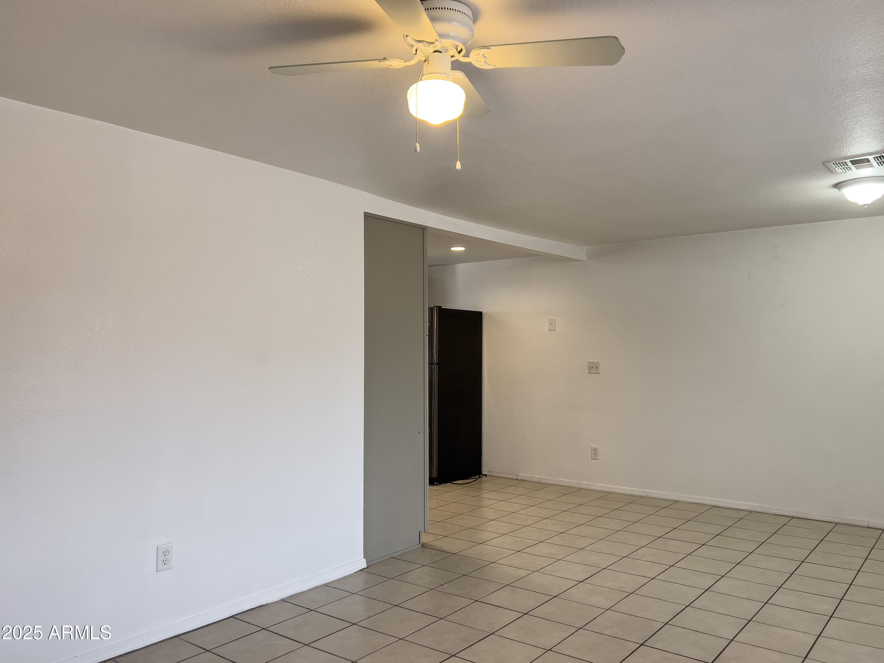 1520 West Sahuaro Drive, Unit B Phoenix, AZ 85029 - Photo 7 of 25 an empty room with closet and a chandelier fan