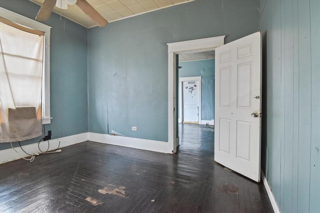 738 1st Street Southwest Paris, TX 75460 - Photo 10 of 25 Spare room with dark wood finished floors and a ceiling fan