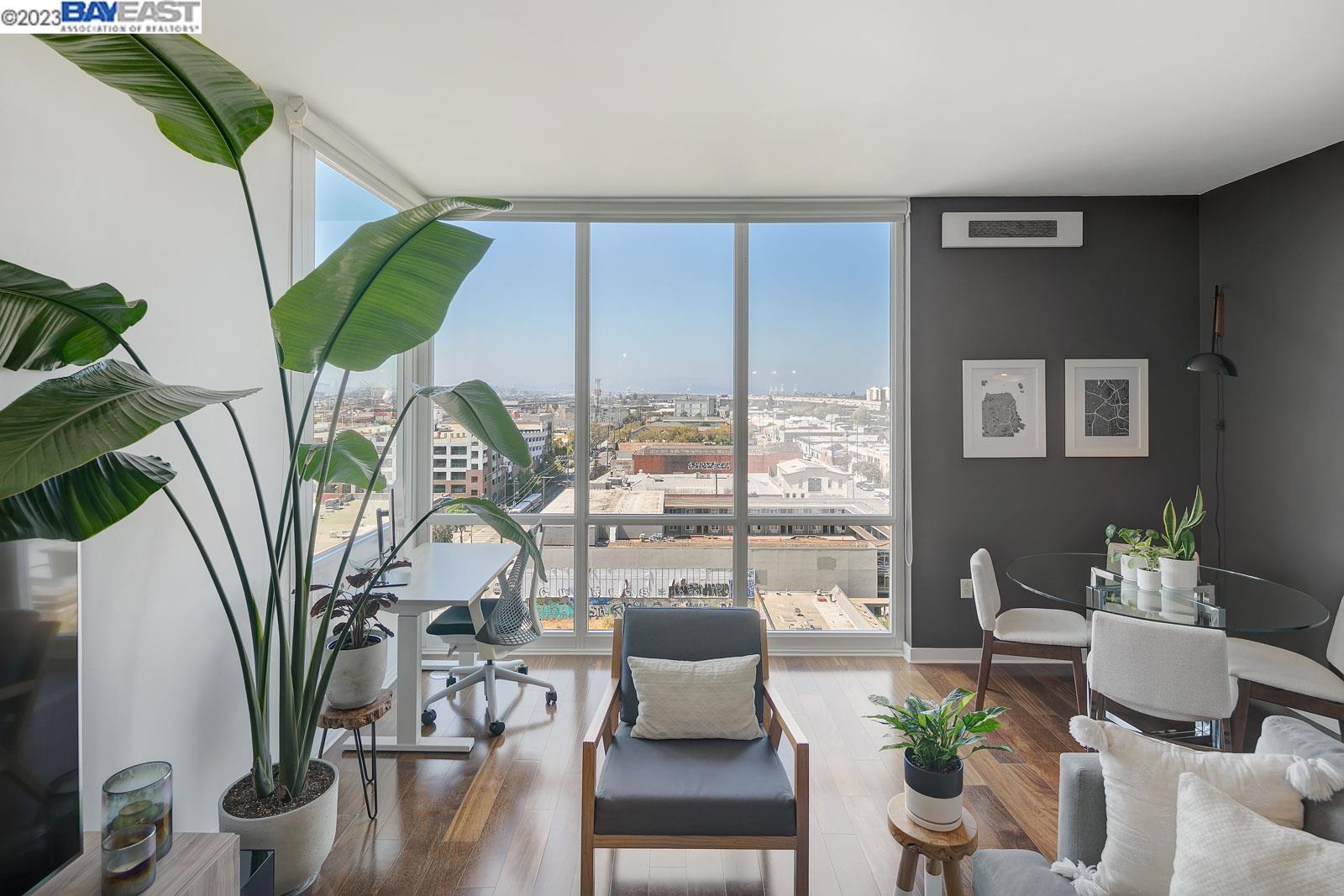 222 Broadway, Unit 1004 Oakland, CA 94607 - Photo 12 of 60 a view of a living room with furniture and floor to ceiling windows