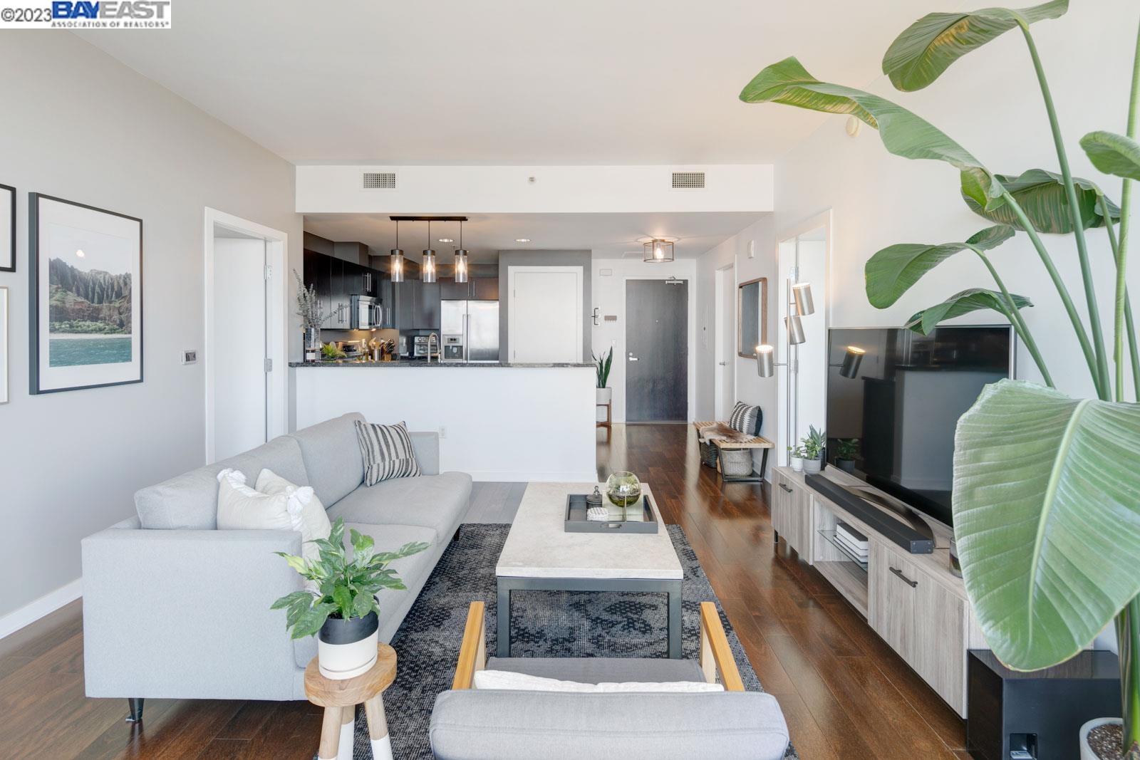 222 Broadway, Unit 1004 Oakland, CA 94607 - Photo 16 of 60 a living room with furniture and a flat screen tv