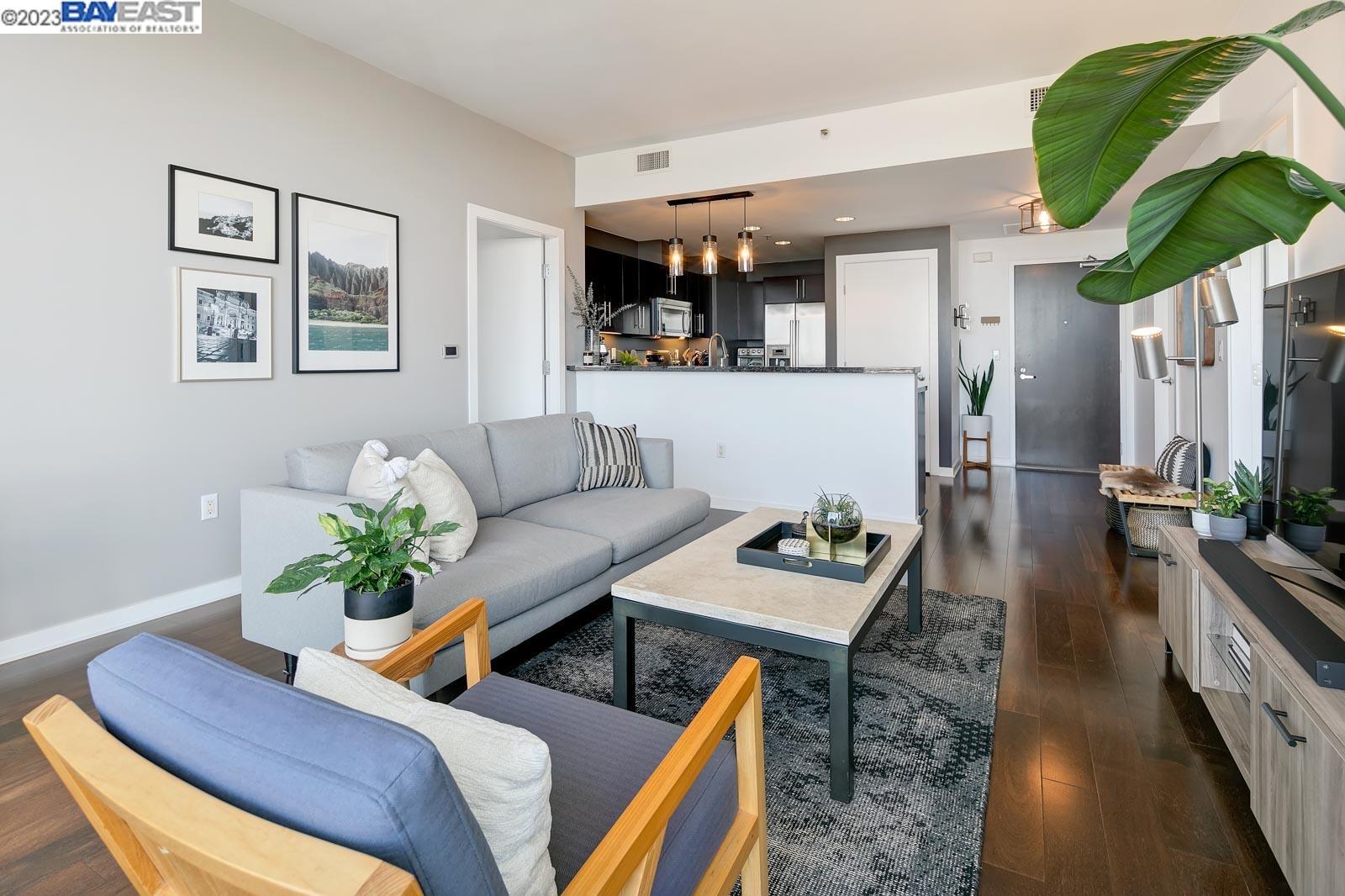 222 Broadway, Unit 1004 Oakland, CA 94607 - Photo 19 of 60 a living room with furniture and a potted plant
