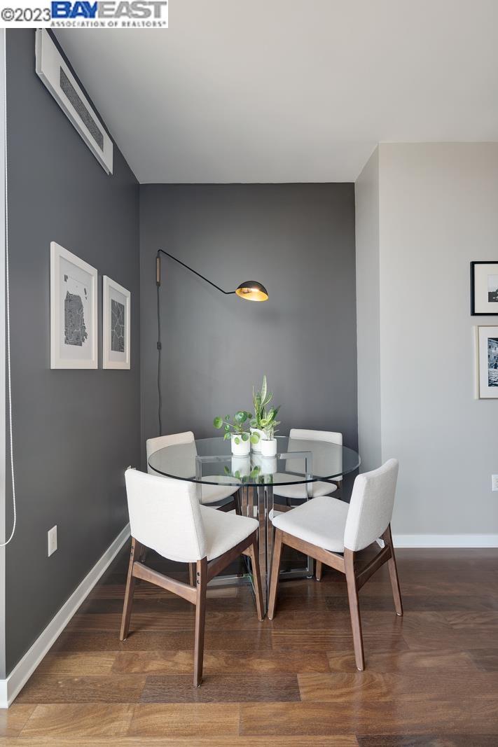 222 Broadway, Unit 1004 Oakland, CA 94607 - Photo 20 of 60 a view of a dining room with furniture and wooden floor