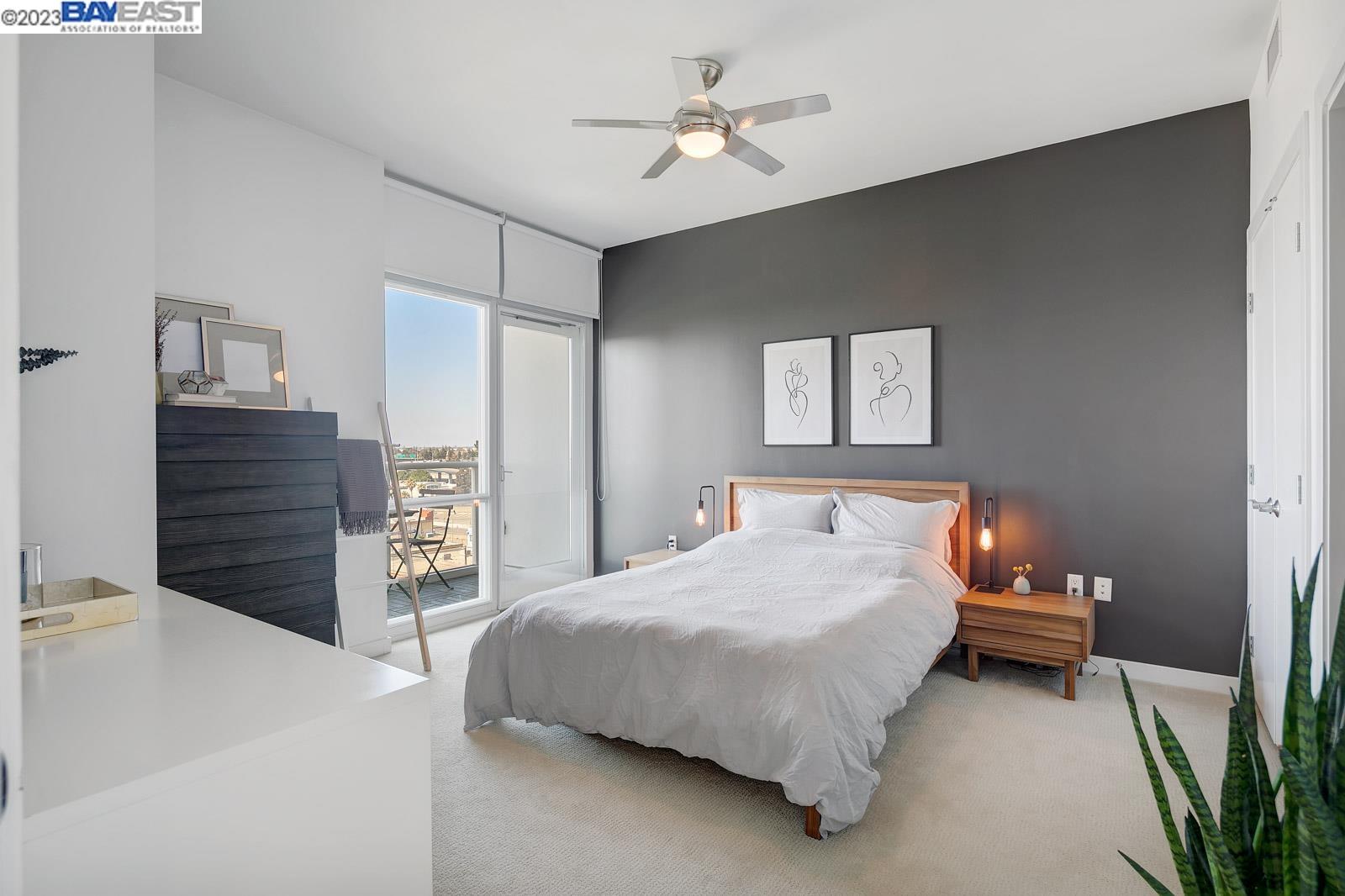 222 Broadway, Unit 1004 Oakland, CA 94607 - Photo 24 of 60 a bedroom with a bed and a chandelier