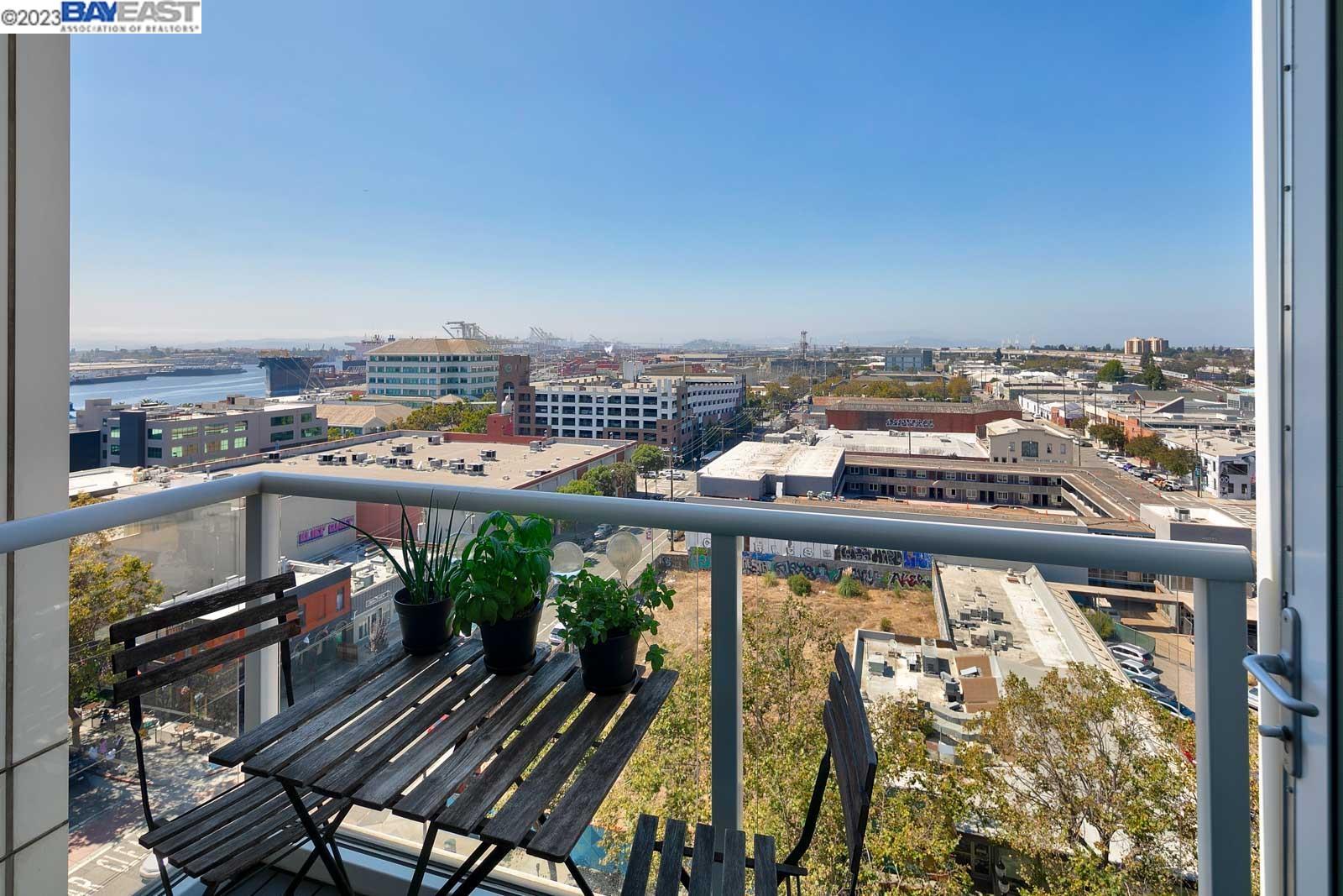 222 Broadway, Unit 1004 Oakland, CA 94607 - Photo 26 of 60 a view of a balcony with wooden chairs
