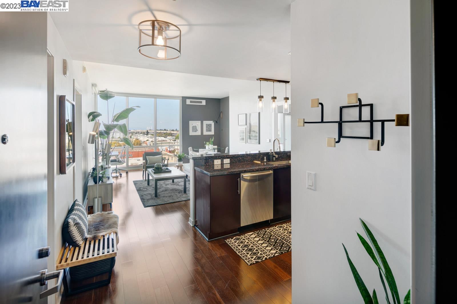 222 Broadway, Unit 1004 Oakland, CA 94607 - Photo 3 of 60 a kitchen with stainless steel appliances granite countertop a refrigerator and a stove top oven