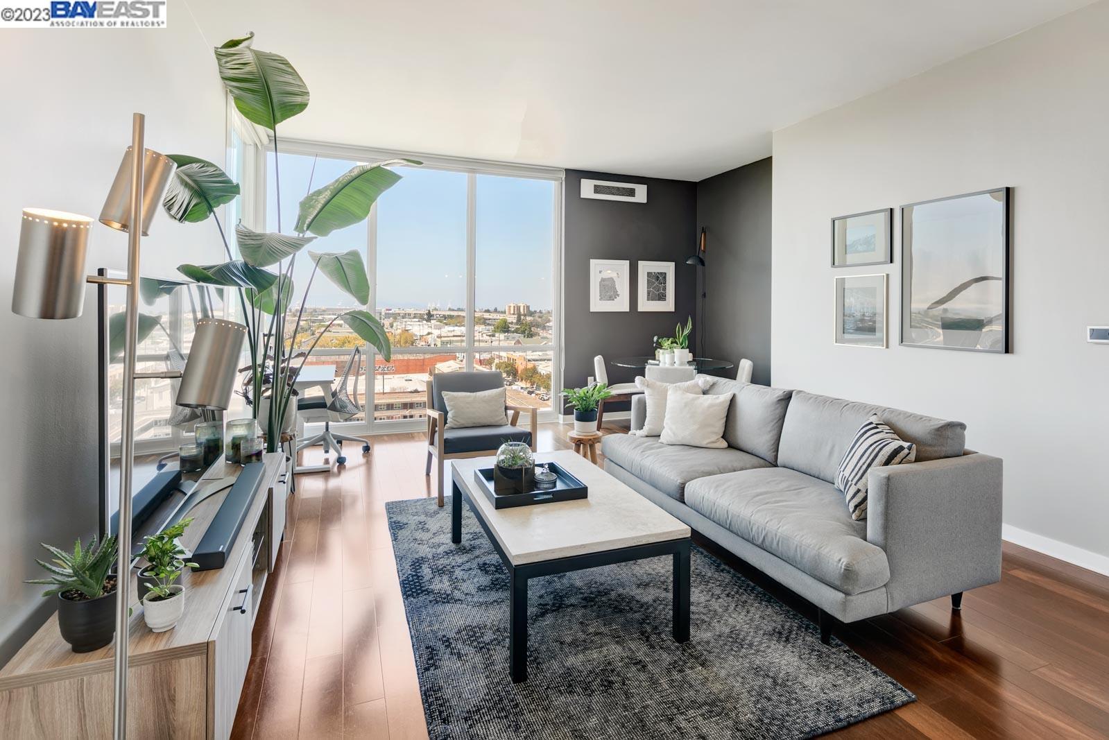 222 Broadway, Unit 1004 Oakland, CA 94607 - Photo 4 of 60 a living room with furniture and wooden floor