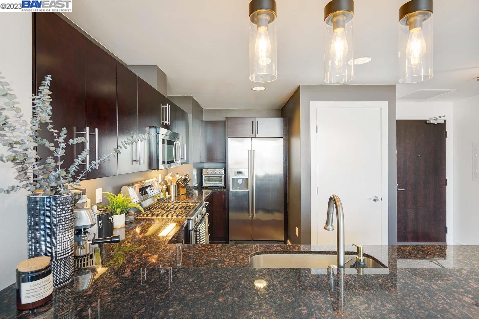 222 Broadway, Unit 1004 Oakland, CA 94607 - Photo 8 of 60 a view of a hallway with dining area and chandelier