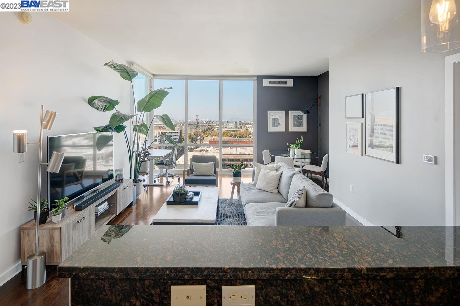 222 Broadway, Unit 1004 Oakland, CA 94607 - Photo 10 of 60 a living room with furniture and a flat screen tv