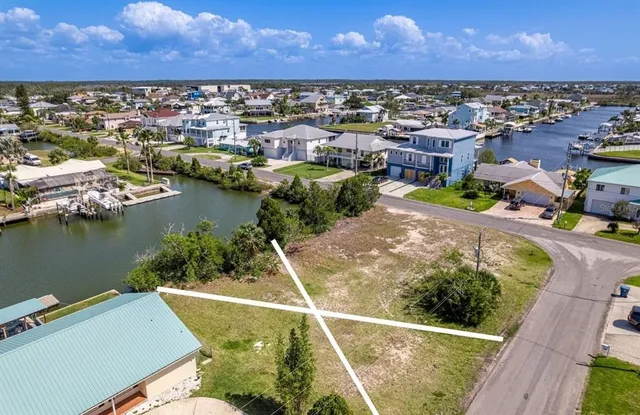 an aerial view of residential houses with outdoor space and lake view