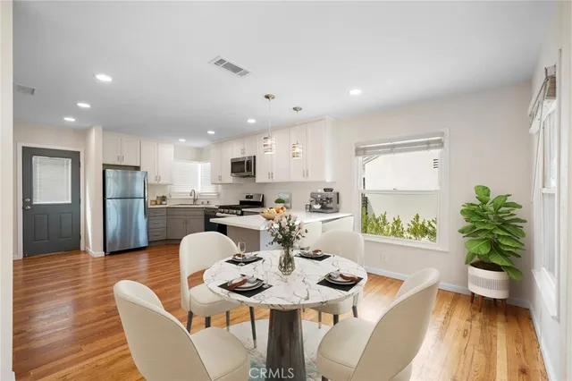 a view of a dining room with furniture and wooden floor