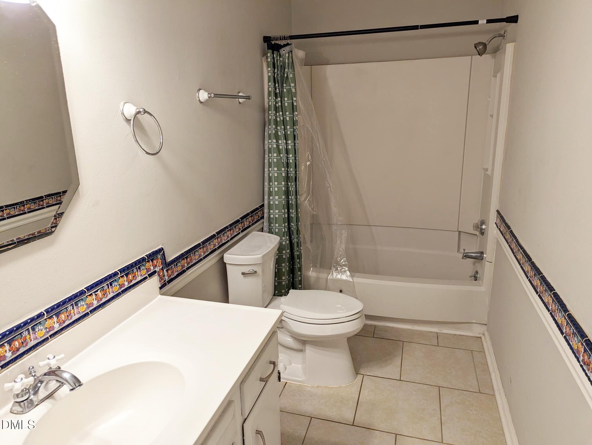 7416 Ray Road Raleigh, NC 27613 - Photo 7 of 12 a bathroom with a sink a toilet and shower