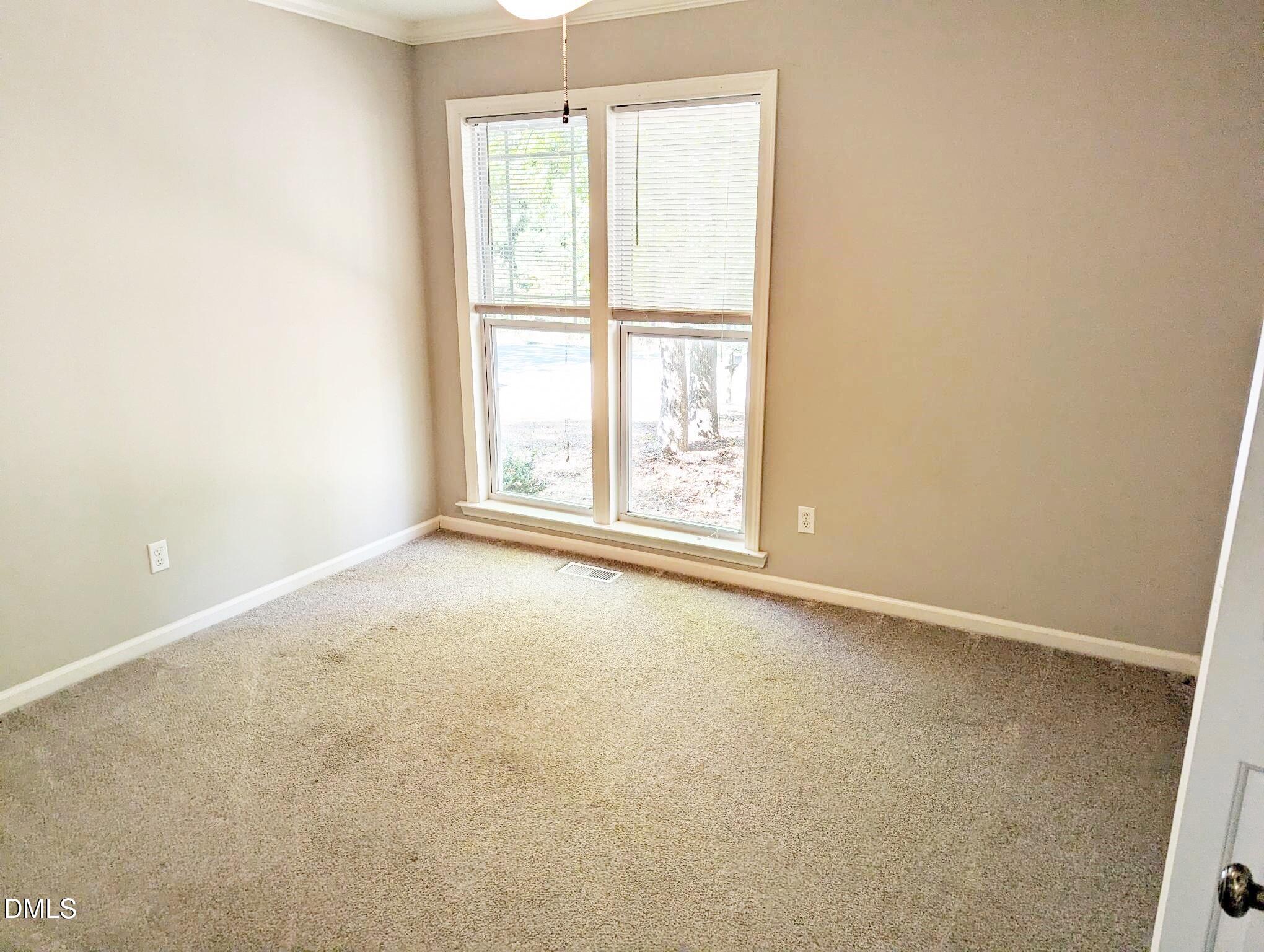 7416 Ray Road Raleigh, NC 27613 - Photo 8 of 12 an empty room with windows